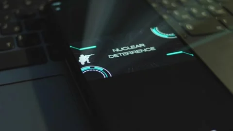 Nuclear Deterrence inscription on smartphone screen with black background Stock Footage 270969744