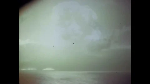 A nuclear drive explodes into a mushroom cloud and a rear admiral discusses 스톡 동영상 88828251