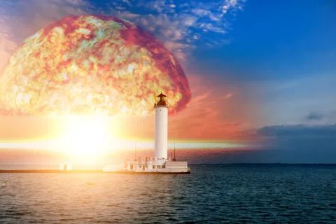 Nuclear explosion on the background of a lighthouse of a coastal city Stock Photos