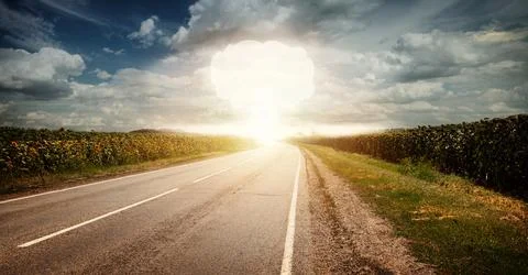 Nuclear explosion in an outdoor setting with blue sky cloud and sunflower f.. Stock Photos