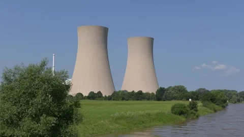 Nuclear power plant and river on sunny day, static wide shot. Video stock 337626347