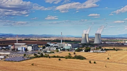 Nuclear power plant landscape with cooling towers and surrounding fields Stock Footage 344536334