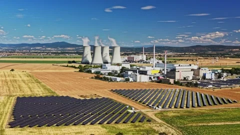 Nuclear power plant located in an open field with solar panels Stock Footage 344537877
