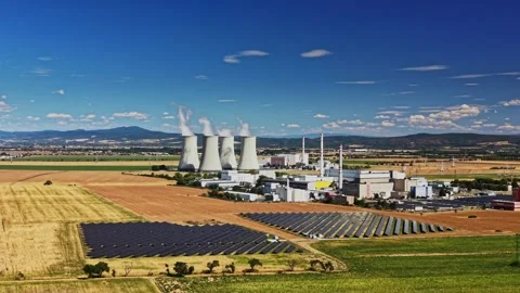 Nuclear power plant operates with adjacent solar panel field Stock Footage 344537763