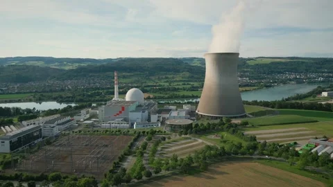Nuclear power plant with pipe and smoke rising into sky against nature landscape Stock Footage 331526711