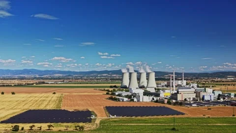 Nuclear power plant with solar panels in field near mountains Stock Footage 344537614