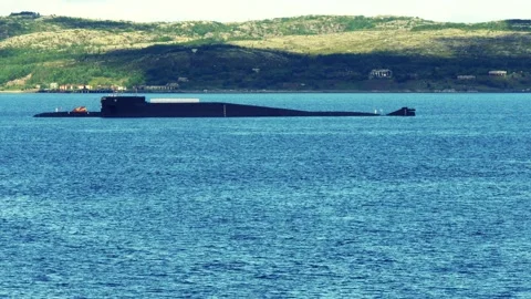 A nuclear-powered submarine against the backdrop of low mountains. Stock Footage 276490385
