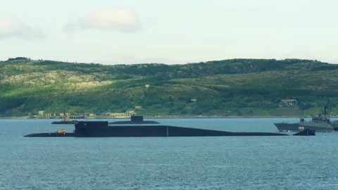 A nuclear submarine with its crew stands at anchor in the Kola Bay. Stock Footage 281729336