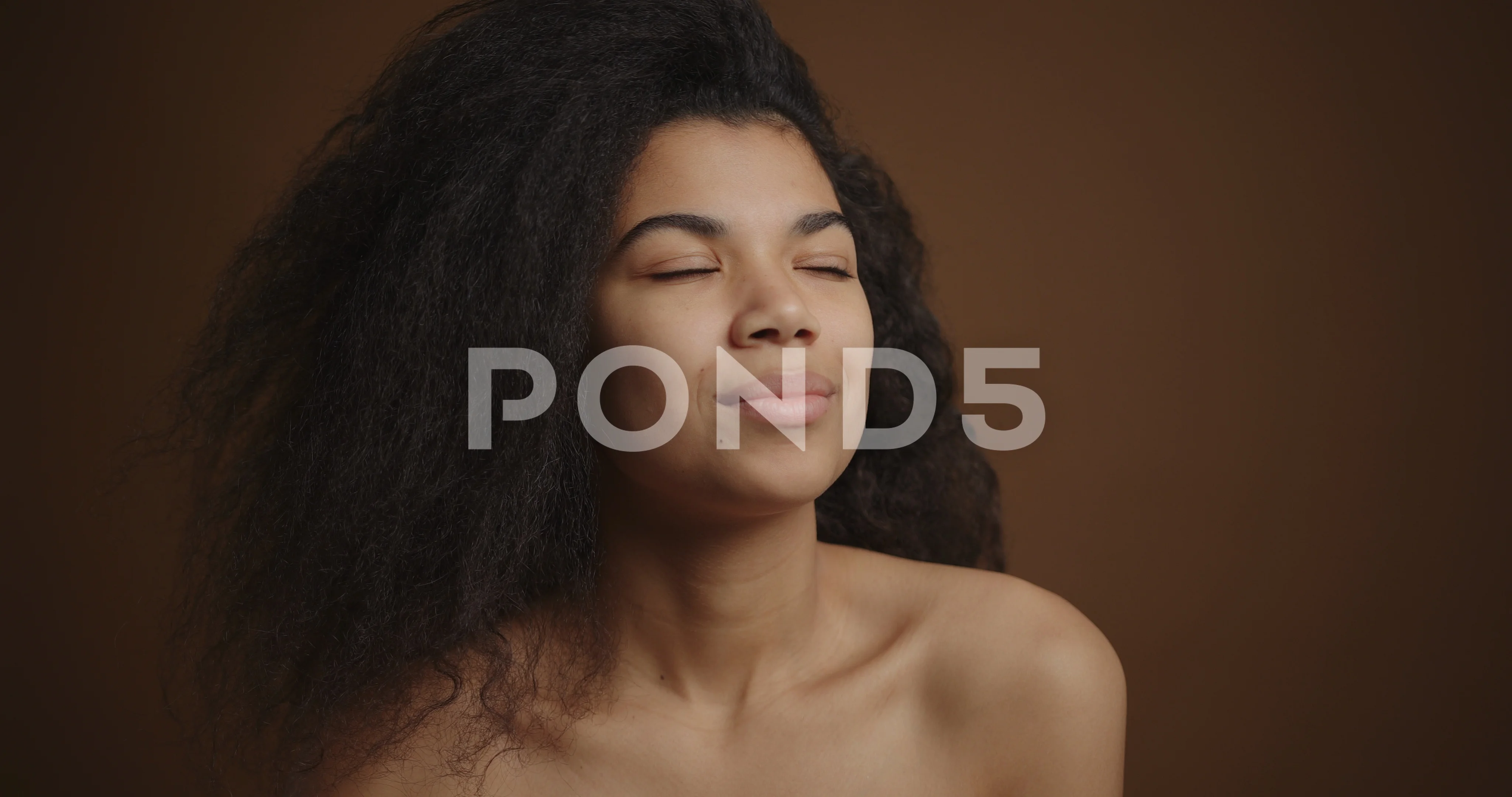 Nude african american woman gently touching her perfect skin face and  shoulders