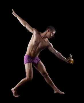 Nude athletic striptease man posing with banana Stock Photos