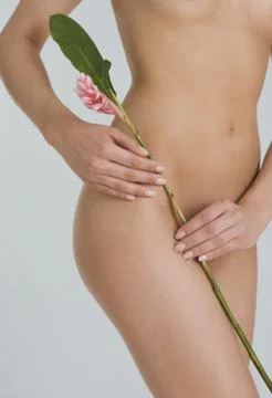 Nude female holding flower Stock Photos