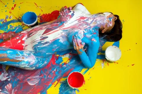 Nude model covered with paint touching breast Stock Photos