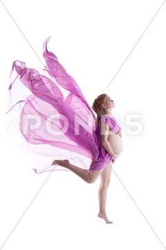 Nude pregnant woman jump with flying fabric Stock Photos
