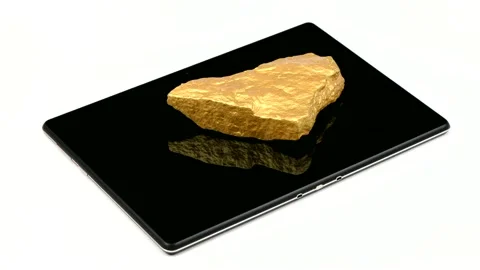 A nugget of gold moves across the surface of a tablet pc. Stock Footage 154814644