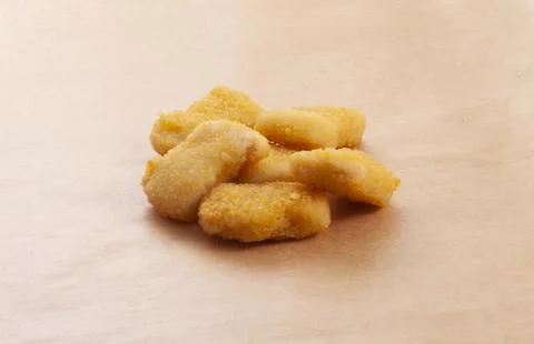 Nuggets on a brown background. Stock Photos