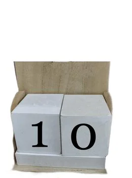 Number 10 on two cubes placed in a wooden support. concept Photos