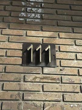 Number 111 on the wall of the building Stock Photos