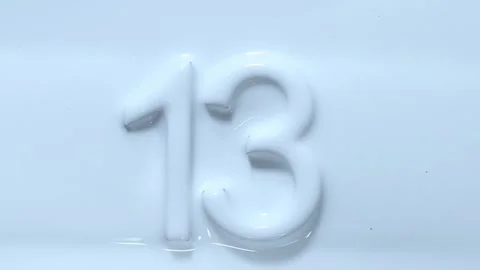 Number 13 revealing a surface of paint in white colour. Stock Footage 275012713