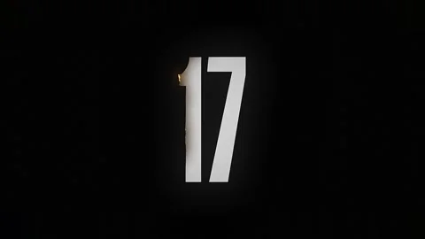 The number 17 burns down and turns into ashes on a black background Stock Footage 169269030