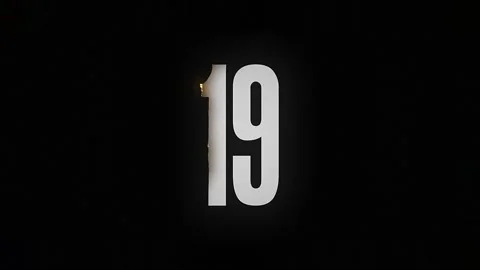 The number 19 burns down and turns into ashes on a black background Stock Footage 169269108