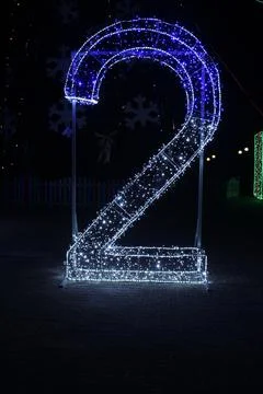 Number 2 two blue white and garlands of lighting. New Year Christmas Illumina Stock Photos