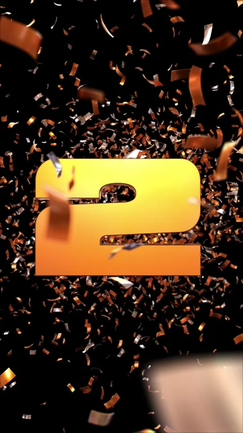 Number 2 which appears passing through a cloud of golden confetti on a blac.. 스톡 동영상 266785116