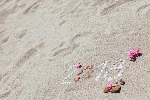 Number 2018 written with shells on the sand Stock Photos