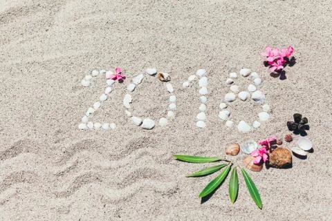 Number 2018 written with shells on the sand Stock Photos