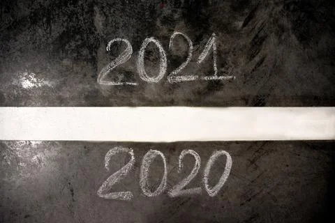 The number of 2020 to 2021 on the asphalt road surface with yellow marking lines Stock Photos