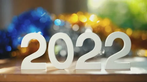 Number 2022 new year text on wooden table with colorful background Stock Footage 165189954