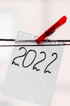 The number 2022 is written on a scrap of notepad. New year 2022. Stock Photos