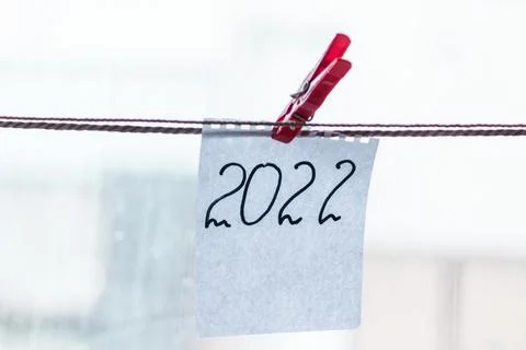 The number 2022 is written on a scrap of notepad. New year 2022. Stock Photos