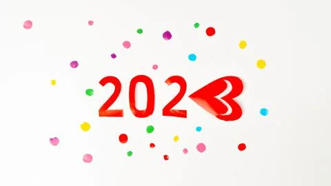 The number 2023 in red in multi-colored confetti, new year with love Stock Photos