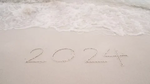 Number 2023 write on sandy beach, ocean wave splash change to 2024 for New Year Stock Footage 252578174