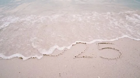 Number 2024 write on sandy beach, ocean wave splash change to new year 2025 Stock Footage 294064956