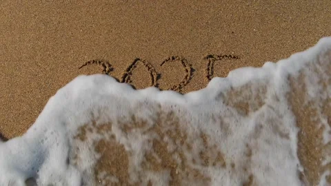 A number 2025 disappears with the help of a sea wave. Stock Footage 317933475