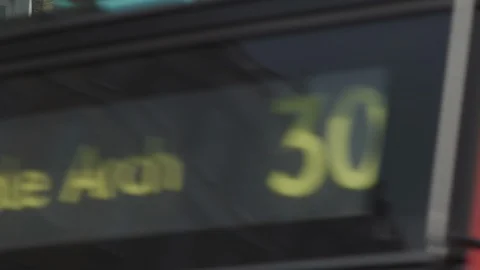 Number 30 red bus passes Baker Street name sign, London Stock Footage 93211346