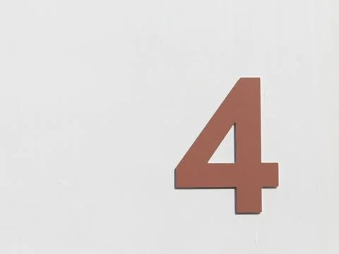 Number 4 on the white wall Foto stock