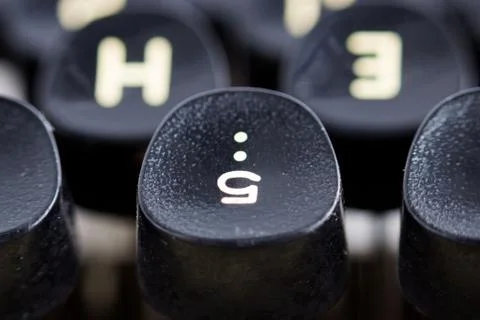 Number 5 upside down on an old Soviet typewriter. finger keys. Stock Photos