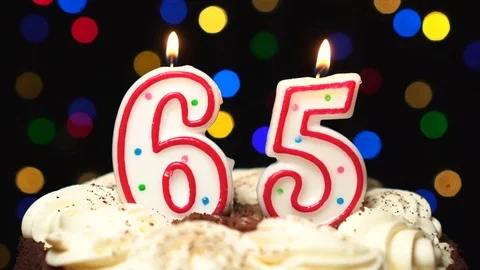 Number 65 on top of cake - sixty five birthday candle burning - blow out at the Stock Footage 85136877