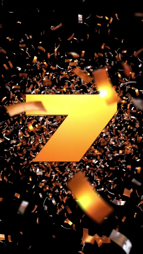 Number 7 which appears passing through a cloud of golden confetti on a blac.. Vidéo 266844419