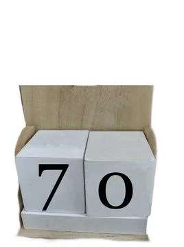 Number 70 on two cubes placed in a wooden support Stock Photos
