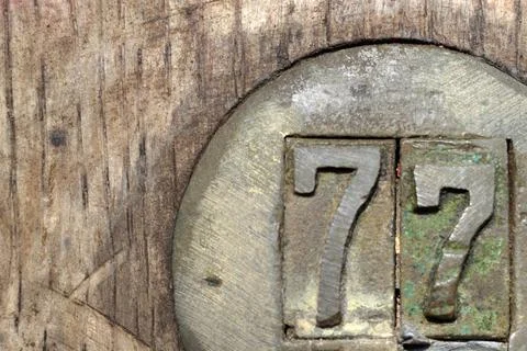 Number 77 in brass  Stock Photos