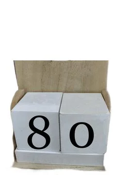 Number 80 on two cubes placed in a wooden support Stock Photos