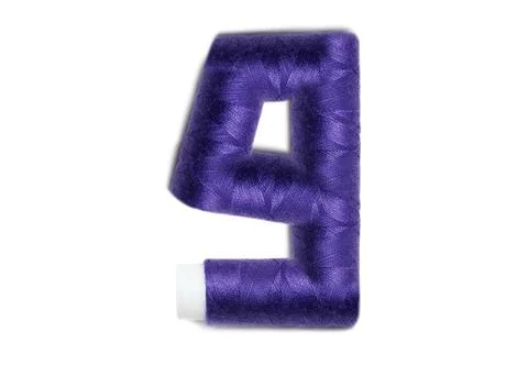 Number 9 from thread spools, isolated on white background. Alphabet concept. Stock Photos