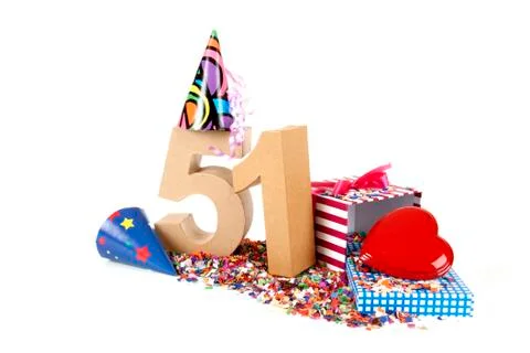 Number of age in a colorful studio setting with paper party hats, a red heart Stock Photos