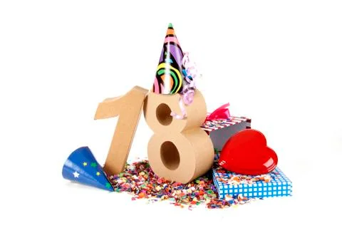 Number of age in a colorful studio setting with paper party hats, a red heart Stock Photos