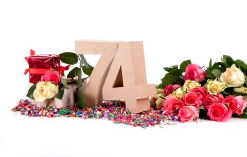 Number of age in a colorful studio setting with fresh roses on a bottom of co Stock-Fotos