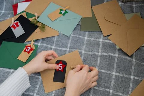 Number on craft envelopes notes with tasks before Christmas holidays. Female Stock Photos