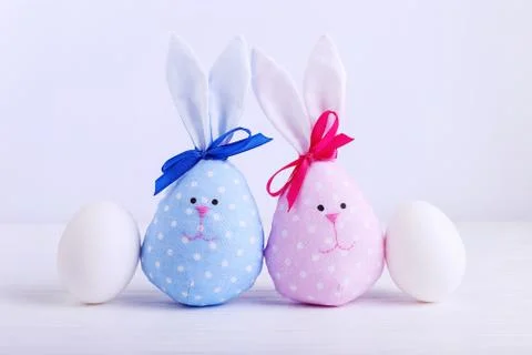 A number of eggs, including two handmade Easter bunny, blue and pink. Stock Photos